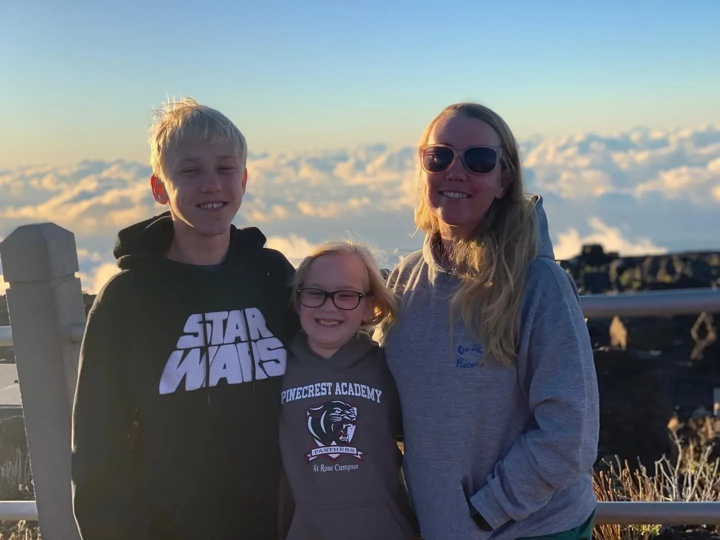 A family standing on top of a mountain.